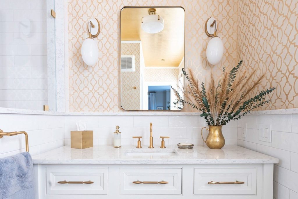 A bright and chic bathroom design with white and gold tones.