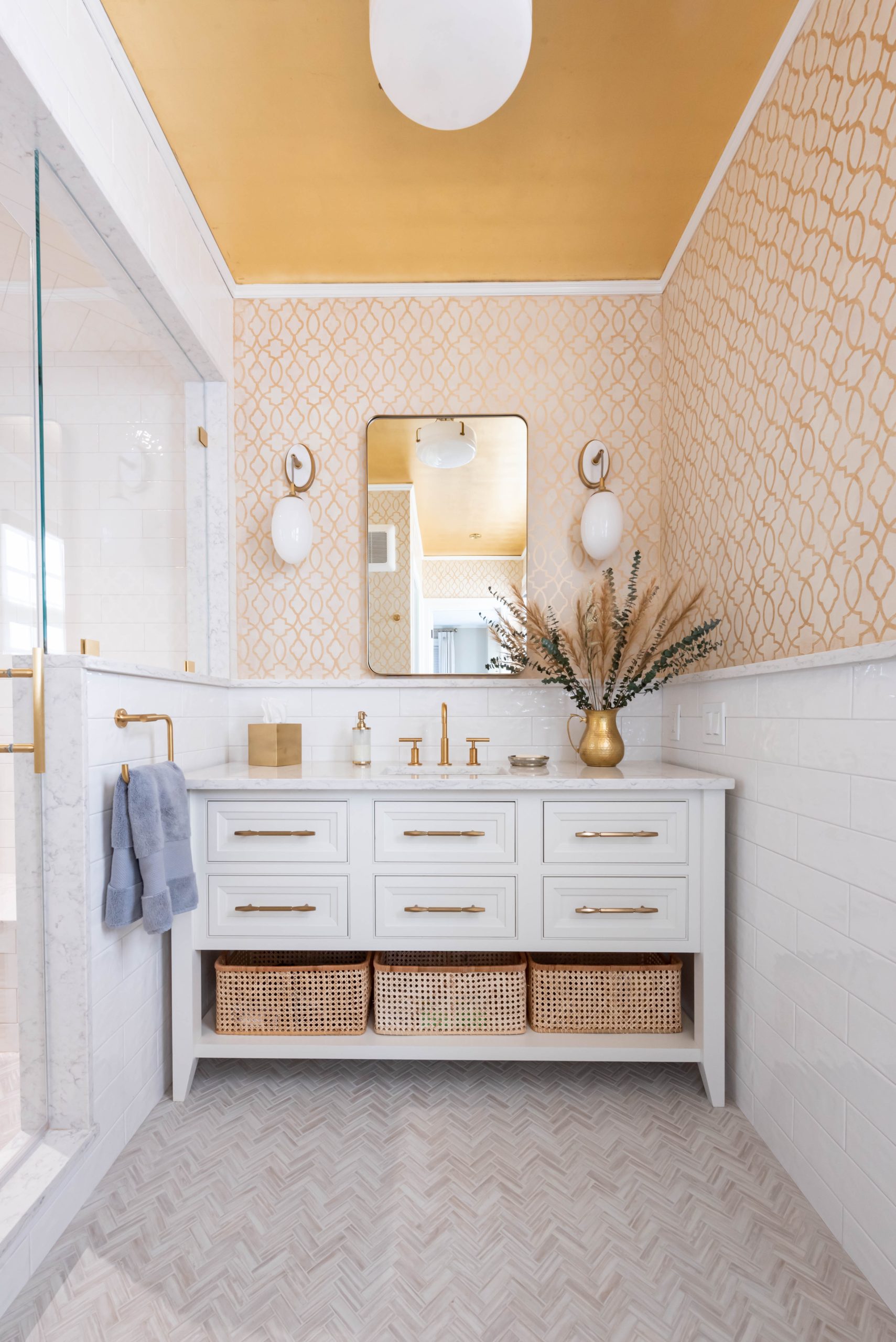 A bright and chic bathroom design with white and gold tones.