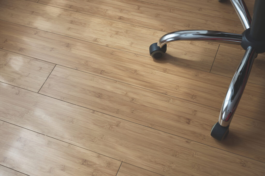 wheels and legs of an office chair on a wooden floor